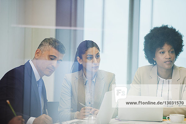 Focused business people in conference room meeting