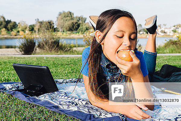 Girl enjoying apple  Long Beach  California  US