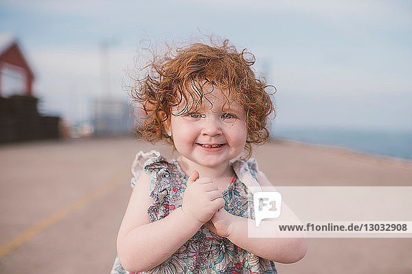 Girl with curly red hair at coast  portrait