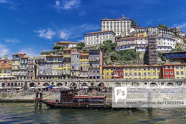 Traditional waterfront houses in the Ribeira district and boat on the Douro River  Porto  Portugal