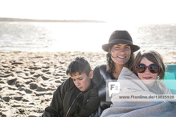 Mother with son and daughter on beach