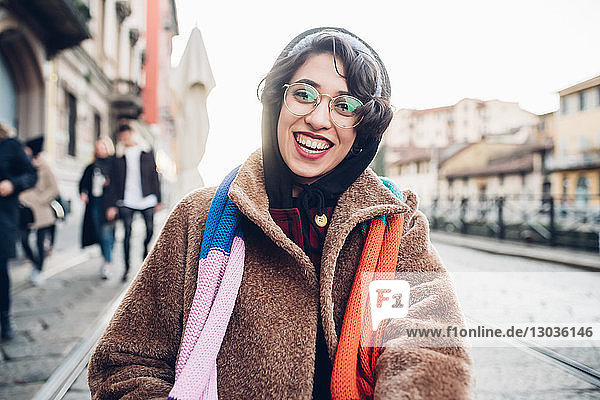 Happy woman on cobbled street  Milan  Italy