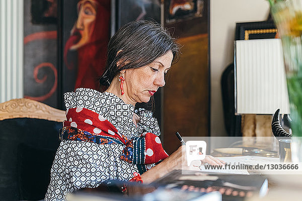 Woman working on designs in her studio