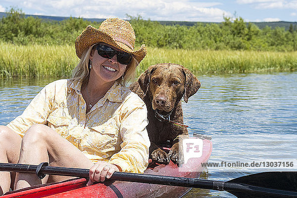 Eine Frau und ihr Hund fahren Kajak auf dem Henrys Fork des Snake River  Rexburg  Idaho  USA