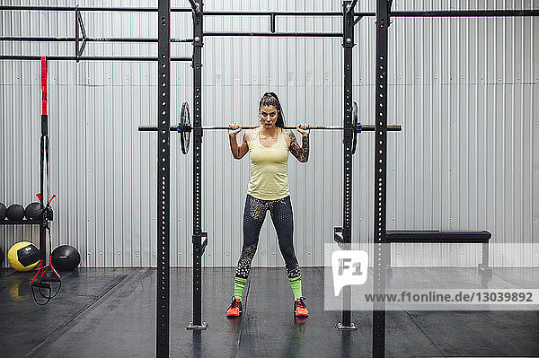 Portrait of athlete lifting deadlift in gym