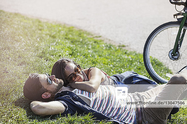 Romantic couple lying on grass at park