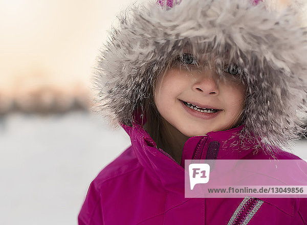 Portrait of cute girl wearing fur coat during winter