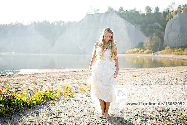 Bride in wedding dress on beach at sunset  Scarborough Bluffs  Toronto  Canada