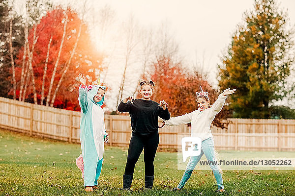 Girls in halloween costume posing in park