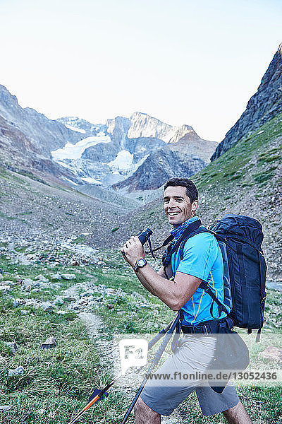 Hiker using binoculars  Mont Cervin  Matterhorn  Valais  Switzerland