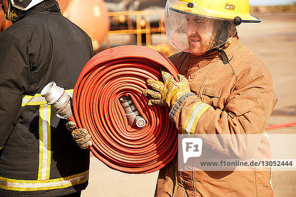 Fireman carrying fire hose reel  Darlington  UK