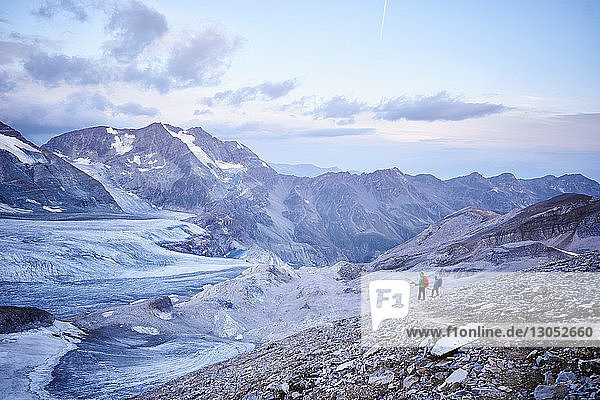 Hiker friends looking at glacier  Mont Cervin  Matterhorn  Valais  Switzerland