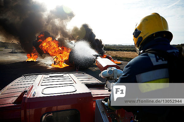 Fireman putting out fire on old training aeroplane  Darlington  UK