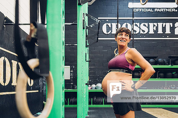 Pregnant woman standing in gym