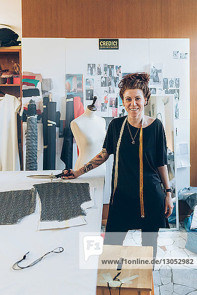 Portrait of fashion designer in her work studio