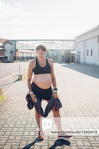 Pregnant woman taking break from workout