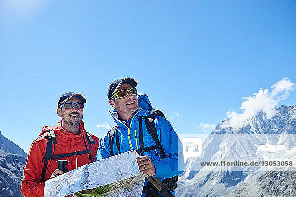 Hiker friends reading map  Mont Cervin  Matterhorn  Valais  Switzerland