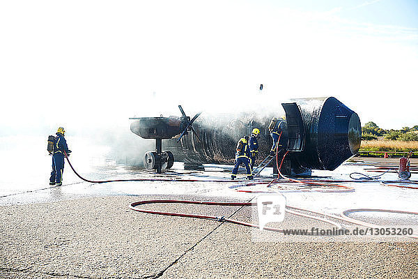 Firemen putting out fire on old training aeroplane  Darlington  UK