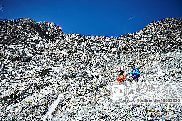 Hikers stopping for break  Mont Cervin  Matterhorn  Valais  Switzerland