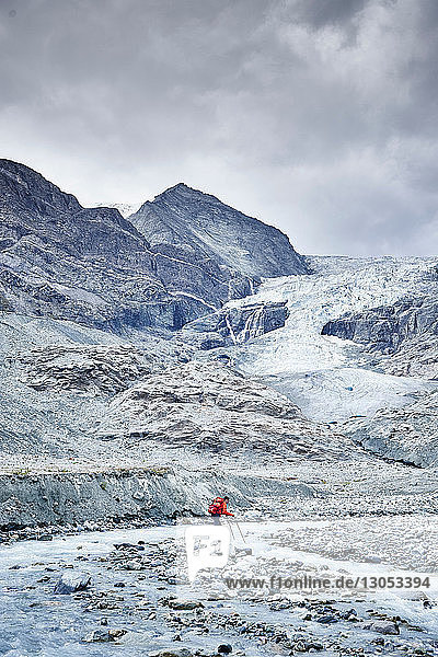 Hiker moving across rocky terrain  Mont Cervin  Matterhorn  Valais  Switzerland