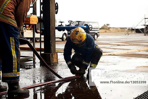 Firemen training  checking fire hose