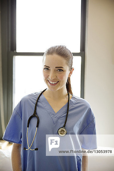 Porträt einer lächelnden Ärztin  die in der Klinik steht