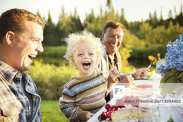 Cheerful family enjoying on picnic table