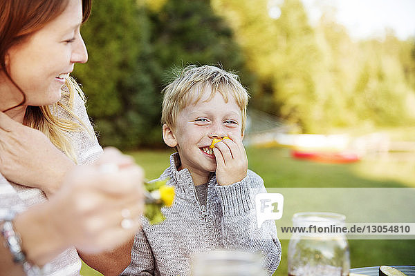 Son enjoying with mother on picnic table
