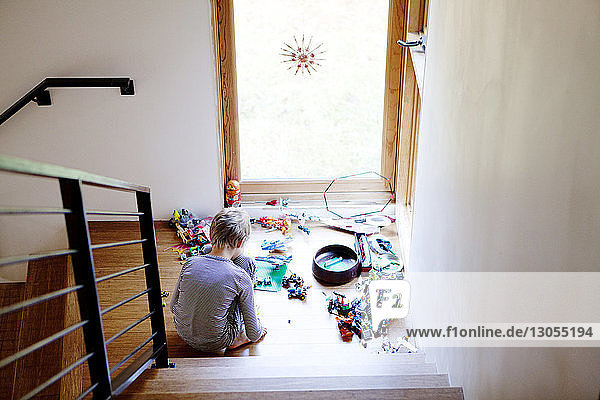 High angle view of boy playing with toys at home