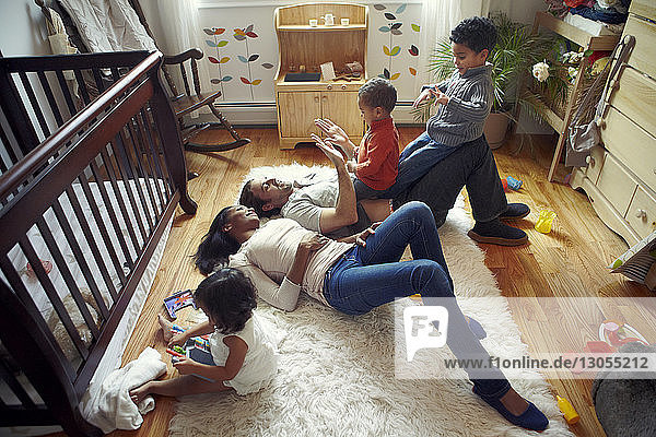 High angle view of parents playing with children at home