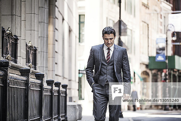 Businessman walking on city street