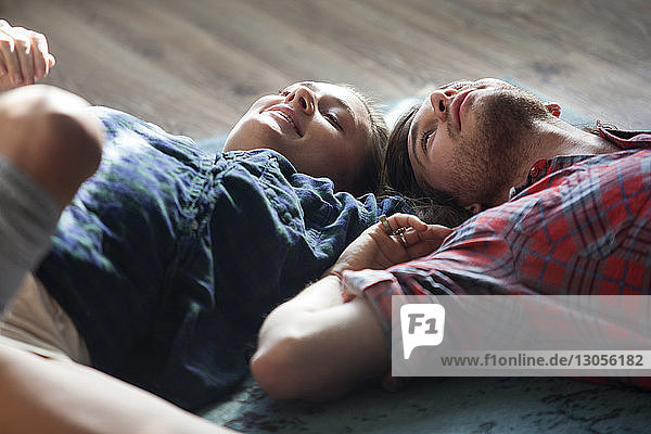 Couple lying on floor at home