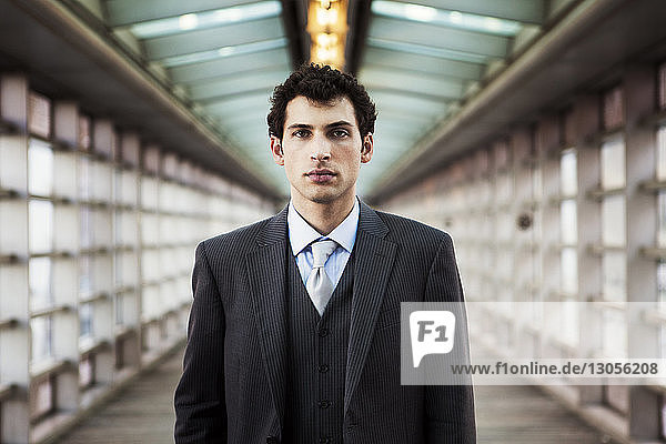 Portrait of confident businessman on covered walkway
