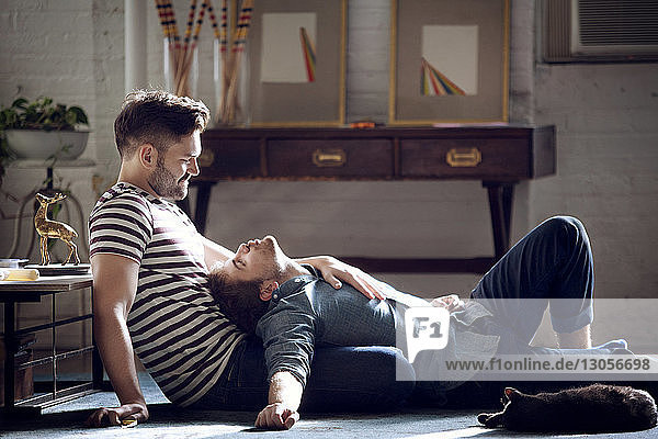 Side view of gay couple sitting at home