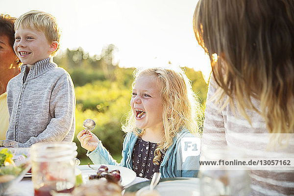Girl enjoying with family on picnic table
