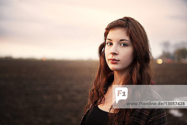 Portrait of confident woman at farm during sunrise