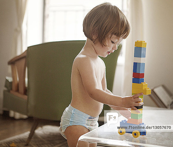 Girl playing with toy blocks at home