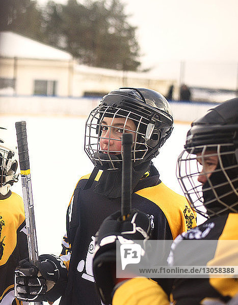 Eishockeyspieler halten Stöcke in der Eishalle