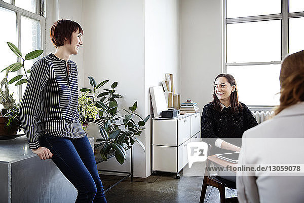 Female business colleagues having discussion in creative office