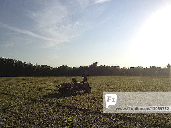 Agricultural machinery on field against sky
