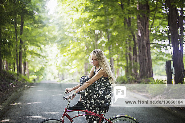 Seitenansicht der auf dem Fahrrad sitzenden Frau