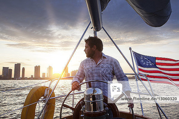 Man looking away while sailing yacht
