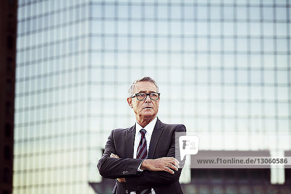 Businessman looking away with arms crossed