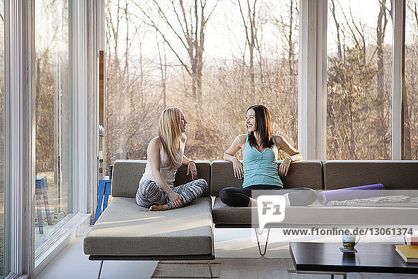 Homosexual females spending leisure time in living room