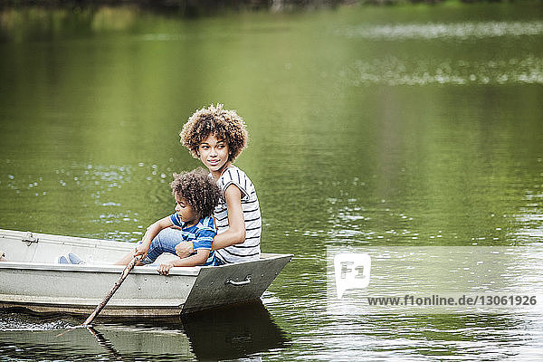 Boy with sister boating in lake