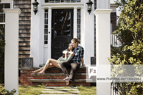 Couple sitting on front stoop