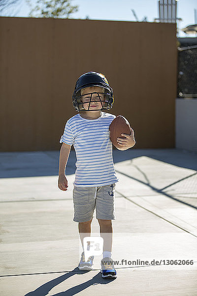 Portrait of happy boy holding football
