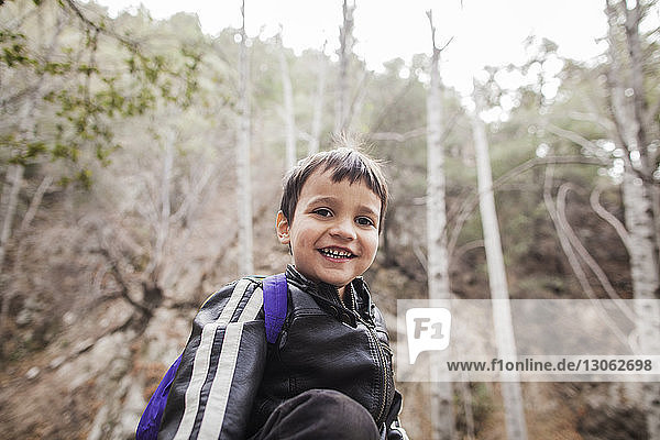 Portrait of boy standing in forest