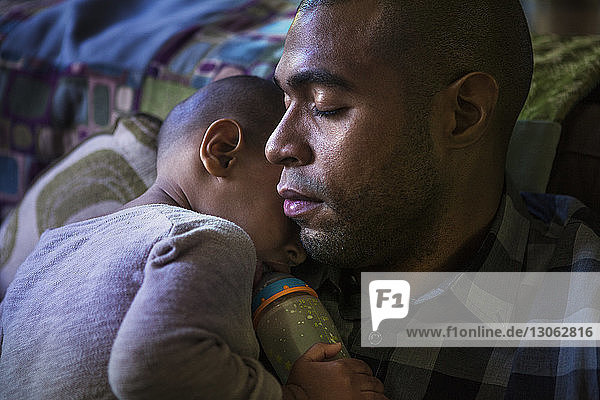 Boy sleeping with father at home