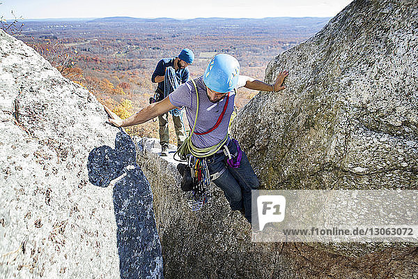 High angle view of friends rock climbing
